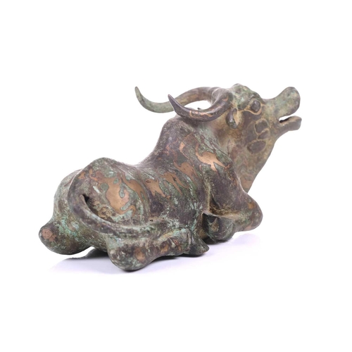 202 - A Chinese bronze and gilt recumbent bull, possibly Zhou dynasty or later, the animal with one leg ou... 