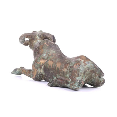 202 - A Chinese bronze and gilt recumbent bull, possibly Zhou dynasty or later, the animal with one leg ou... 