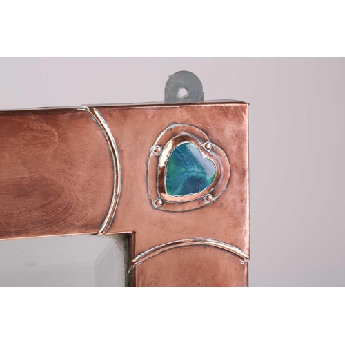 210 - An Arts & Crafts style planished copper rectangular wall mirror the overlaid corners with applied Ru... 