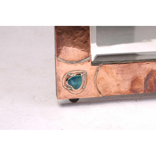 210 - An Arts & Crafts style planished copper rectangular wall mirror the overlaid corners with applied Ru... 