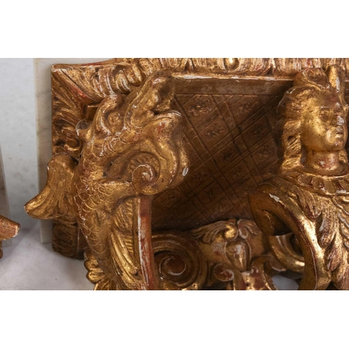 213 - A pair of carved wood and gilt gesso wall brackets with shaped marble tops, late 19th century/ early... 