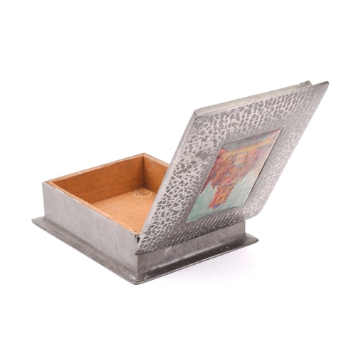 215 - A Liberty & Co (?) model 083 hammered pewter and hard enamel table box, the hinged cover set with a ... 