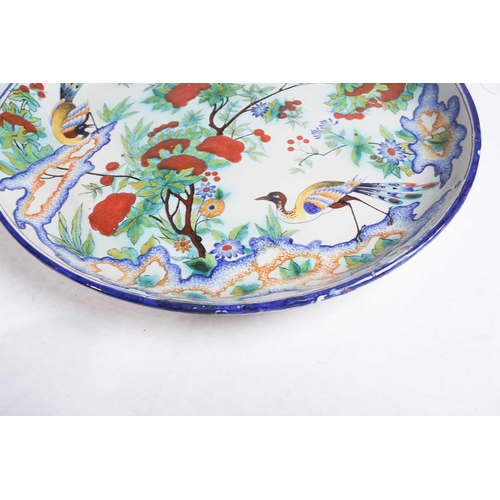 228 - A Cantagalli Pottery charger, depicting exotic birds and butterflies among a flowering tree, painted... 