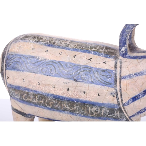 231 - An Islamic pottery ram, probably Iran, the cylindrical body decorated with bands of black and blue, ... 