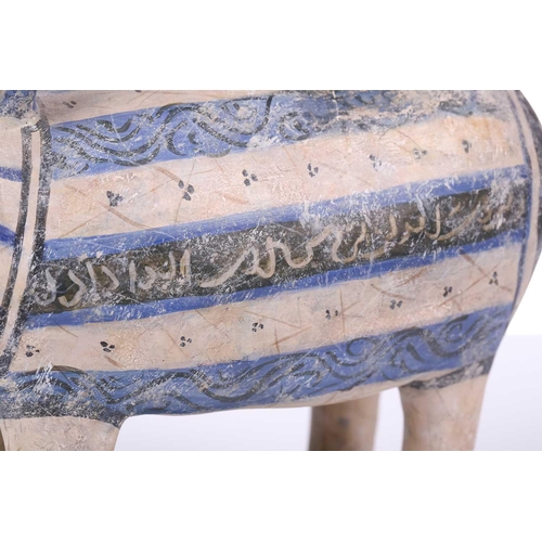 231 - An Islamic pottery ram, probably Iran, the cylindrical body decorated with bands of black and blue, ... 