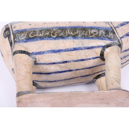 231 - An Islamic pottery ram, probably Iran, the cylindrical body decorated with bands of black and blue, ... 