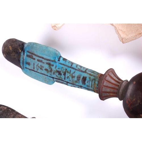 233 - An Egyptian basalt-type Shabti with a hieroglyphic panel to the torso mounted in an old museum-type ... 