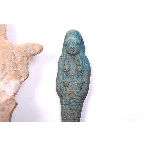 233 - An Egyptian basalt-type Shabti with a hieroglyphic panel to the torso mounted in an old museum-type ... 