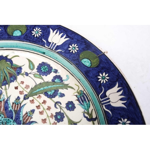 245 - A Torquato Castellani Faience Charger, with blue and turquoise Iznik style floral design, within a b... 