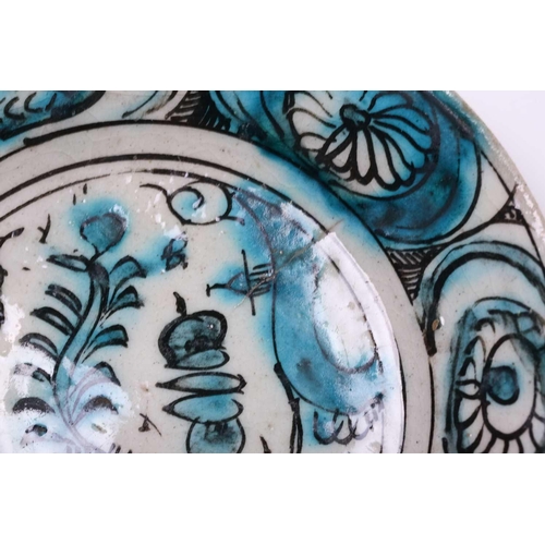 246 - An Iznic polychrome plate, 17th/18th century, decorated in an underglaze turquoise, with various out... 