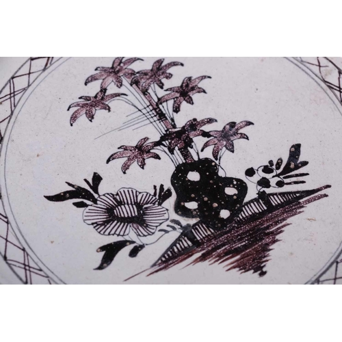 247 - A Liverpool Delft circular charger, circa 1760, decorated in manganese to the centre with bamboo, ro... 