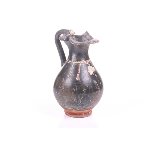 248 - A black painted oinoche (wine ewer), In the Greek Gnathian pottery style, with a rounded, fluted bod... 