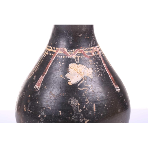 248 - A black painted oinoche (wine ewer), In the Greek Gnathian pottery style, with a rounded, fluted bod... 