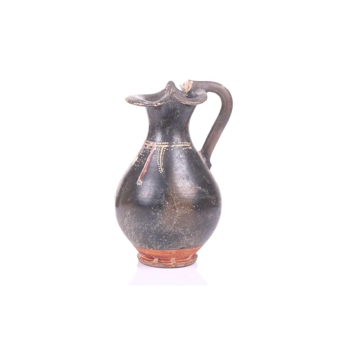 248 - A black painted oinoche (wine ewer), In the Greek Gnathian pottery style, with a rounded, fluted bod... 