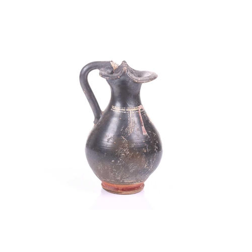 248 - A black painted oinoche (wine ewer), In the Greek Gnathian pottery style, with a rounded, fluted bod... 