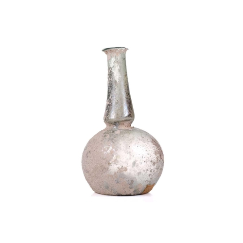 250 - A Roman glass bulbous flask with everted rim, signs of oxidation and encrusted soil to the iridescen... 