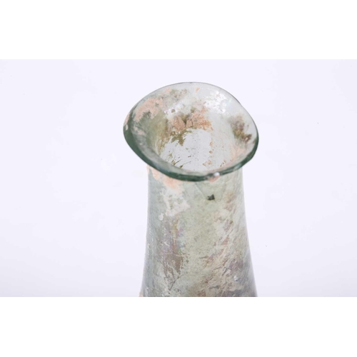 250 - A Roman glass bulbous flask with everted rim, signs of oxidation and encrusted soil to the iridescen... 