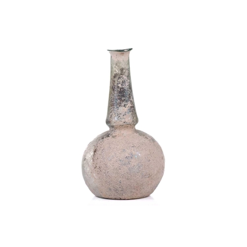 250 - A Roman glass bulbous flask with everted rim, signs of oxidation and encrusted soil to the iridescen... 