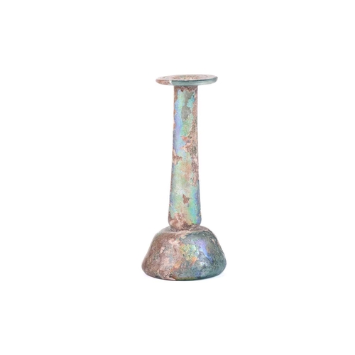 256 - A Roman glass Unguentarium flask with rolled everted rim and stepped conical body, with an extensive... 