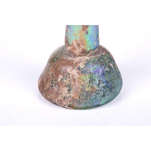 256 - A Roman glass Unguentarium flask with rolled everted rim and stepped conical body, with an extensive... 