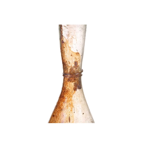 257 - A Roman glass inverted baluster form flask with trail decorated neck, bearing an old handwritten col... 