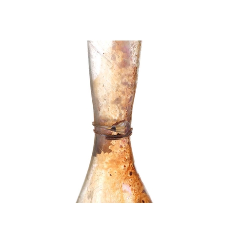 257 - A Roman glass inverted baluster form flask with trail decorated neck, bearing an old handwritten col... 