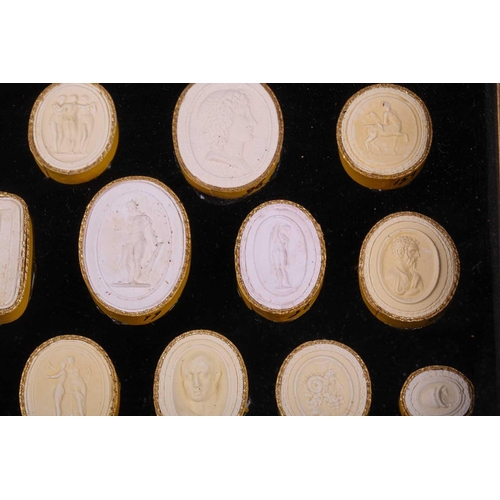 273 - A collection of Grand Tour plaster intaglios, each numbered, contained in two glazed box frames, 20 ... 