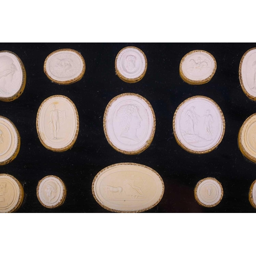 273 - A collection of Grand Tour plaster intaglios, each numbered, contained in two glazed box frames, 20 ... 