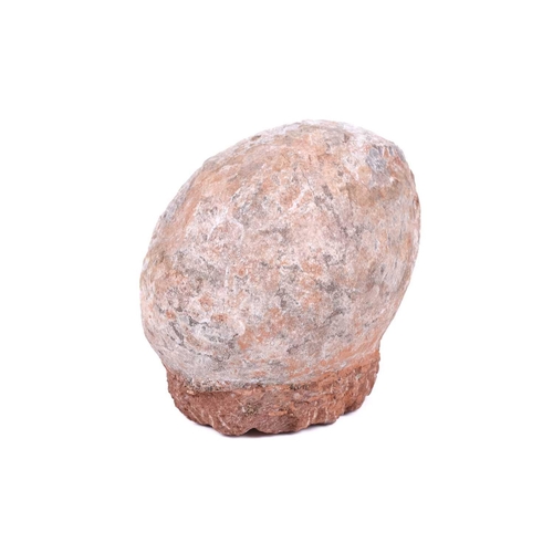 298 - A fossilised dinosaur egg, in a red stone base, 14 cm total height, 15 cm wide