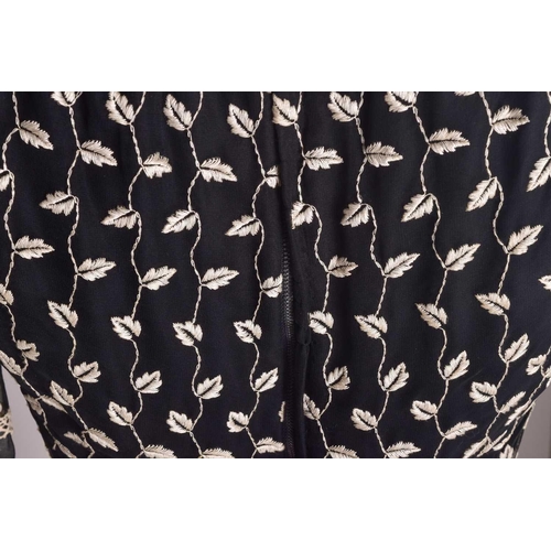 103 - Christian Dior; a black and embroidered long dress, with long sleeves and high neckline, 'Boutique' ... 