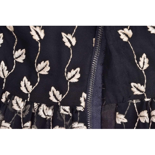 103 - Christian Dior; a black and embroidered long dress, with long sleeves and high neckline, 'Boutique' ... 