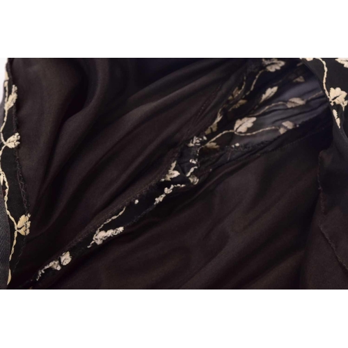 103 - Christian Dior; a black and embroidered long dress, with long sleeves and high neckline, 'Boutique' ... 