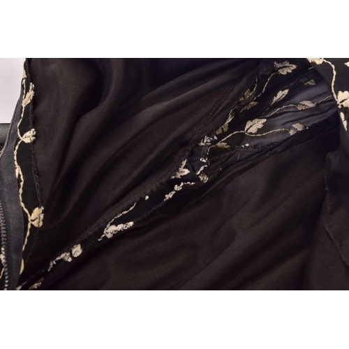 103 - Christian Dior; a black and embroidered long dress, with long sleeves and high neckline, 'Boutique' ... 