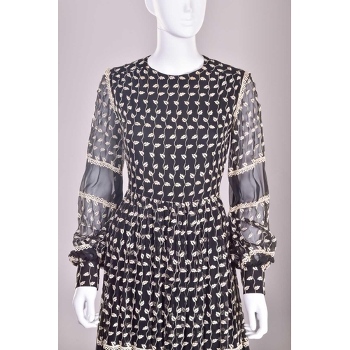 103 - Christian Dior; a black and embroidered long dress, with long sleeves and high neckline, 'Boutique' ... 