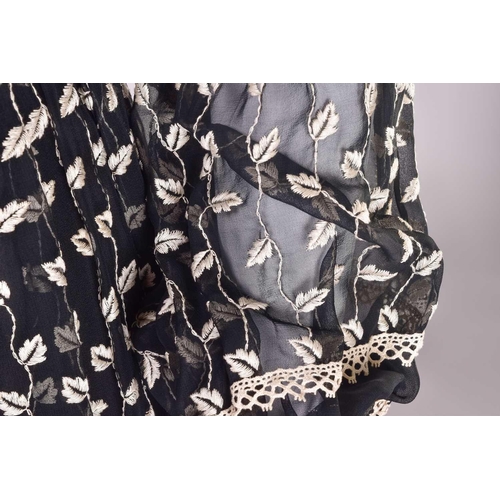 103 - Christian Dior; a black and embroidered long dress, with long sleeves and high neckline, 'Boutique' ... 