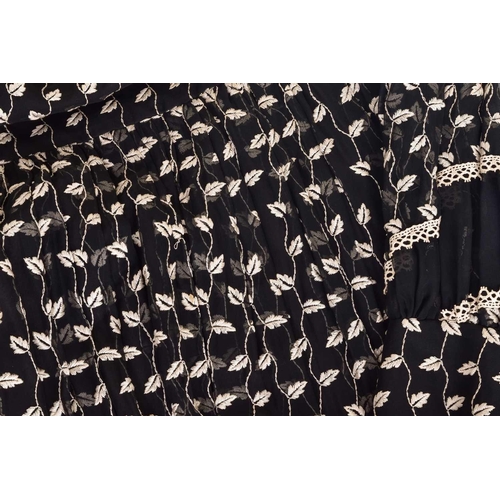 103 - Christian Dior; a black and embroidered long dress, with long sleeves and high neckline, 'Boutique' ... 