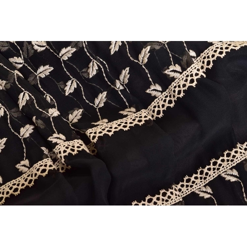 103 - Christian Dior; a black and embroidered long dress, with long sleeves and high neckline, 'Boutique' ... 