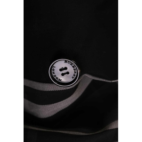 105 - Burberry - a 'Kensington' trench coat in black, lined with Burberry check pattern, double-breasted b... 