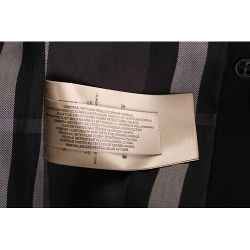 105 - Burberry - a 'Kensington' trench coat in black, lined with Burberry check pattern, double-breasted b... 