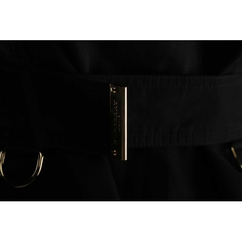 105 - Burberry - a 'Kensington' trench coat in black, lined with Burberry check pattern, double-breasted b... 