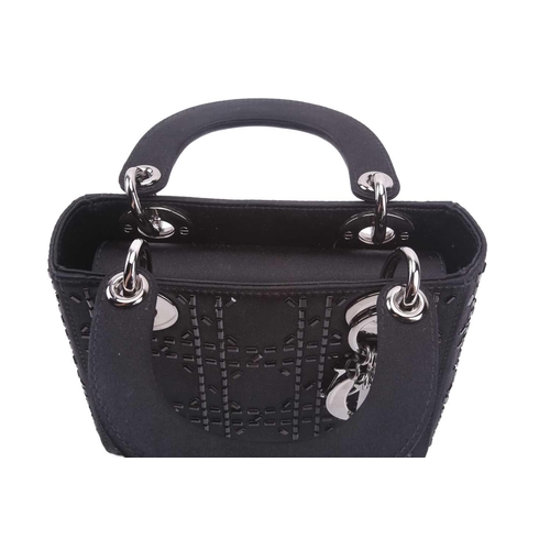 47 - Christian Dior - a mini Lady Dior evening bag in black satin, circa 2007, embellished with baguette-... 