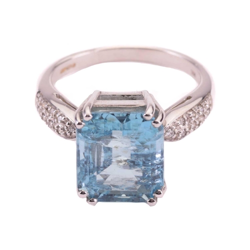 10 - An aquamarine and diamond ring, set with an emerald cut aquamarine to the centre, measuring 12 x 10.... 