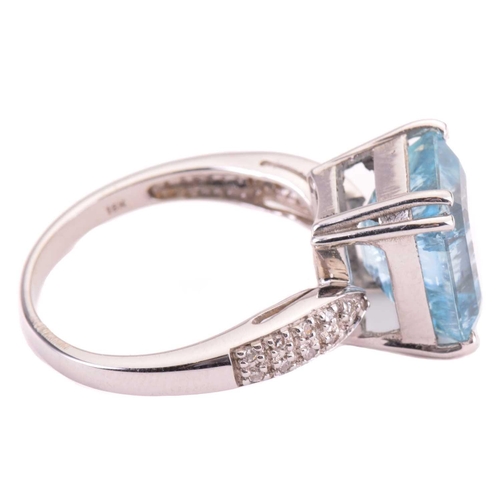 10 - An aquamarine and diamond ring, set with an emerald cut aquamarine to the centre, measuring 12 x 10.... 