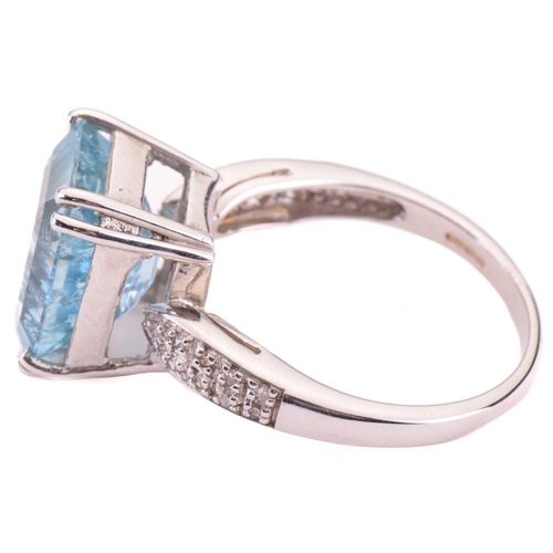 10 - An aquamarine and diamond ring, set with an emerald cut aquamarine to the centre, measuring 12 x 10.... 