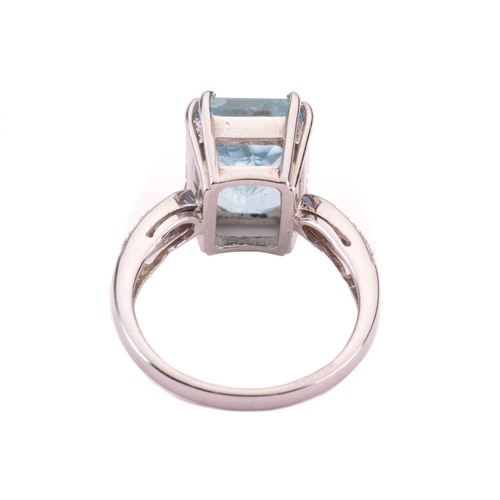 10 - An aquamarine and diamond ring, set with an emerald cut aquamarine to the centre, measuring 12 x 10.... 