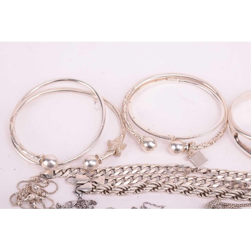 109 - A collection of assorted white metal jewellery including various bangles, bracelets necklace chains ... 