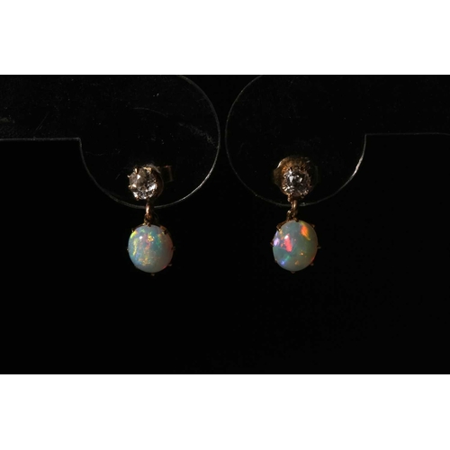 110 - A pair of diamond and opal drop earrings, each comprising an old-cut diamond surmount, approximately... 