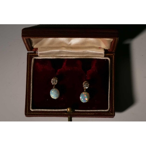 110 - A pair of diamond and opal drop earrings, each comprising an old-cut diamond surmount, approximately... 