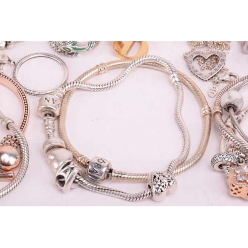 128 - A collection of branded jewellery comprising ten Pandora bangles some with charms, a Thomas Sabo sna... 