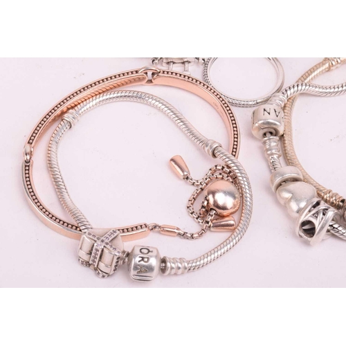 128 - A collection of branded jewellery comprising ten Pandora bangles some with charms, a Thomas Sabo sna... 